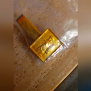 Gold-tone Square Accent clip of a firefighter